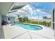 A screened-in backyard pool sits next to a patio with dining and lounge furniture at 11895 Claremont Dr, Port Charlotte, FL 33981