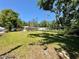 Expansive backyard view featuring green grass and scattered trees at 1317 Venetia St, Nokomis, FL 34275