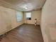 This bedroom features two windows, overhead lighting, and laminate floors at 1317 Venetia St, Nokomis, FL 34275