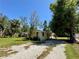 Lovely single-story home with a stucco exterior, complemented by well-established trees and a gravel driveway at 1317 Venetia St, Nokomis, FL 34275
