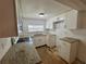 Bright kitchen showcasing white cabinets, granite countertops, and a stainless steel sink at 1317 Venetia St, Nokomis, FL 34275