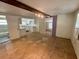 Spacious living area showcasing hardwood floors, a glimpse of the updated kitchen and a renovated bathroom at 1317 Venetia St, Nokomis, FL 34275