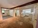 Open-concept living space with hardwood floors, ample natural light, and a view to the kitchen at 1317 Venetia St, Nokomis, FL 34275