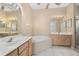 Bright bathroom featuring tile floors, double vanity sinks, bathtub and walk-in shower at 1363 New Forest Ln, Osprey, FL 34229