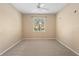 Neutral bedroom with carpet flooring, a ceiling fan, and a window offering natural light and views of the outdoors at 1363 New Forest Ln, Osprey, FL 34229