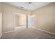 Cozy bedroom featuring neutral carpeting, a ceiling fan, and an open doorway to an adjacent room, creating a flexible space at 1363 New Forest Ln, Osprey, FL 34229