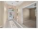 Inviting foyer with tile flooring, a stylish light fixture, and a view into adjacent rooms, enhancing the home's openness at 1363 New Forest Ln, Osprey, FL 34229
