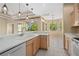 Modern kitchen showcasing ample counter space, stainless steel appliances, and a breakfast bar that overlooks a sunny dining area at 1363 New Forest Ln, Osprey, FL 34229