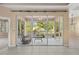 Screened lanai offering outdoor living with ceiling fan, overlooking landscaped backyard through the sliding glass doors at 1363 New Forest Ln, Osprey, FL 34229