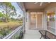 Lanai overlooking a serene outdoor view with a pond, palm trees and landscaping at 1363 New Forest Ln, Osprey, FL 34229