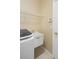 Functional laundry area with a sink, modern washer and dryer, and handy storage shelves at 1363 New Forest Ln, Osprey, FL 34229