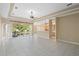 Spacious living room featuring tile floors, a tray ceiling, and sliding glass doors leading to an outdoor patio at 1363 New Forest Ln, Osprey, FL 34229