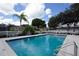 Beautiful community pool with lounge chairs and tables, providing a resort-style experience for residents at 1363 New Forest Ln, Osprey, FL 34229