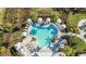 Aerial view of the community pool with tropical landscaping at 16202 Isola Pl, Bradenton, FL 34211