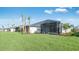 A spacious backyard with a well-maintained lawn and a view of neighboring homes and palm trees at 16202 Isola Pl, Bradenton, FL 34211