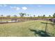 A well maintained fenced dog park with green grass and a bench in a pet-friendly community at 16202 Isola Pl, Bradenton, FL 34211