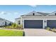 Beautiful home exterior with a two-car garage, brick paved driveway, and landscaped lawn at 16202 Isola Pl, Bradenton, FL 34211