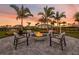 Community fire pit surrounded by comfortable seating and lush landscaping, perfect for evening gatherings at 16202 Isola Pl, Bradenton, FL 34211