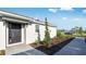 Home exterior featuring a dark front door, brick paver walkway, and manicured landscaping at 16202 Isola Pl, Bradenton, FL 34211