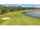 Beautiful golf course view with green fairway, sand trap, and pond at 16202 Isola Pl, Bradenton, FL 34211