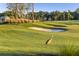 Scenic golf course featuring sand traps, green fairway and a sandhill crane at 16202 Isola Pl, Bradenton, FL 34211