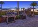 Outdoor grilling area with barbecue grills, a table, and chairs, perfect for cooking out and relaxing at 16202 Isola Pl, Bradenton, FL 34211