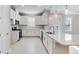 Modern kitchen featuring white cabinets, stainless steel appliances, and a large quartz countertop island at 16202 Isola Pl, Bradenton, FL 34211