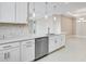 Contemporary kitchen with white cabinetry, a stainless steel dishwasher, and modern pendant lighting at 16202 Isola Pl, Bradenton, FL 34211