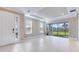 Bright living room featuring sliding glass doors, tile flooring, and a view of the backyard at 16202 Isola Pl, Bradenton, FL 34211