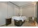 Relaxing massage room with adjustable bed, cabinet storage, and comfortable seating at 16202 Isola Pl, Bradenton, FL 34211