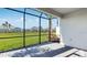 A screened patio with stone floors and a view of the manicured lawn and neighborhood at 16202 Isola Pl, Bradenton, FL 34211