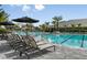 Resort-style pool with lounge chairs and tropical landscaping at the community center at 16202 Isola Pl, Bradenton, FL 34211