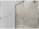 Tiled walk-in shower with glass doors and a built-in seat at 16202 Isola Pl, Bradenton, FL 34211