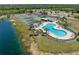 Gorgeous aerial view of community pool, tennis courts, and waterfront with lush surroundings at 175 Kings Hwy # 428 B8, Punta Gorda, FL 33983