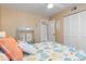 Inviting bedroom with a coastal-themed quilt, mirrored closet, and seahorse wall decor at 175 Kings Hwy # 428 B8, Punta Gorda, FL 33983