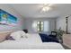 A calming bedroom includes a large window, dresser, and beach-themed decor at 175 Kings Hwy # 428 B8, Punta Gorda, FL 33983