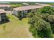 Well-maintained building exterior surrounded by lush landscaping, mature trees, and a green lawn at 175 Kings Hwy # 428 B8, Punta Gorda, FL 33983
