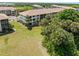 Lovely building exterior with lush landscaping, mature trees, and a well-manicured lawn at 175 Kings Hwy # 428 B8, Punta Gorda, FL 33983