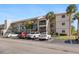 Multi-story condo with parking, balconies, and beautiful palm tree landscaping at 175 Kings Hwy # 428 B8, Punta Gorda, FL 33983