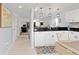 Open kitchen view, white cabinets, stainless steel appliances, and view to living room at 175 Kings Hwy # 428 B8, Punta Gorda, FL 33983