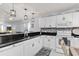 Open kitchen featuring white cabinets, stainless steel appliances, and breakfast bar at 175 Kings Hwy # 428 B8, Punta Gorda, FL 33983