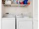 Functional laundry area featuring a washer, dryer, and overhead storage shelf at 175 Kings Hwy # 428 B8, Punta Gorda, FL 33983
