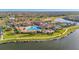 Aerial view of a community with a large pool, tennis courts, and beautiful landscaping at 20228 Lagente Cir, Venice, FL 34293