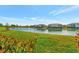 Picturesque backyard with lush green grass and a tranquil pond view at 20228 Lagente Cir, Venice, FL 34293