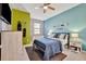 Stylish bedroom featuring a full bed, ceiling fan, and large window at 20228 Lagente Cir, Venice, FL 34293