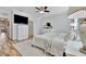 Comfortable bedroom featuring a ceiling fan and a mounted television at 20228 Lagente Cir, Venice, FL 34293