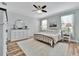 Charming bedroom with a ceiling fan, dresser, and bright natural light at 20228 Lagente Cir, Venice, FL 34293