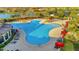 Large, resort-style community pool surrounded by lounge chairs and red umbrellas at 20228 Lagente Cir, Venice, FL 34293
