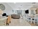 Open-concept living room with a large sectional sofa, desk, and dining area at 20228 Lagente Cir, Venice, FL 34293