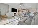 Spacious living room featuring a large sectional sofa, television, and dining area at 20228 Lagente Cir, Venice, FL 34293